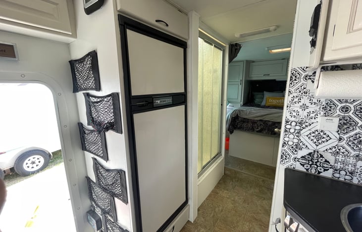 Refrigerador and shower stall.