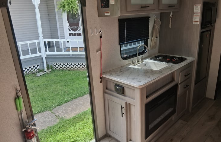 Nice size kitchen with two stove tops, microwave and refrigerator, also cozy heater for those cool night's.