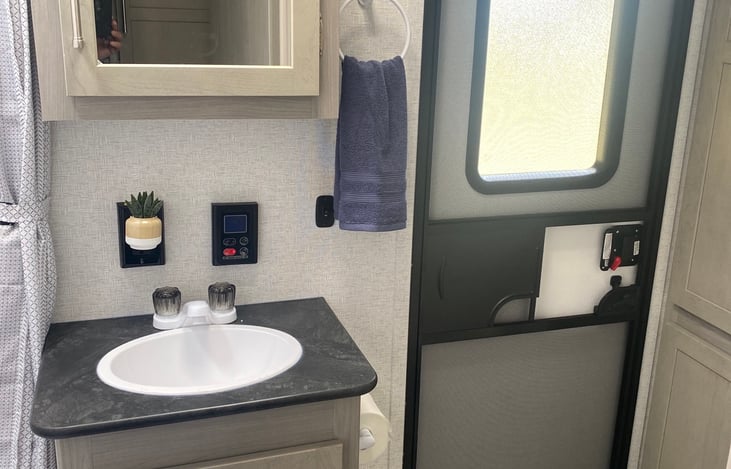 Bathroom with unlimited hot water and outdoor exit.