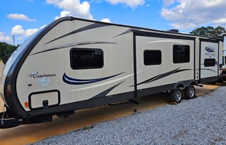 Large RV with outdoor kitchen, fireplace, and TVs