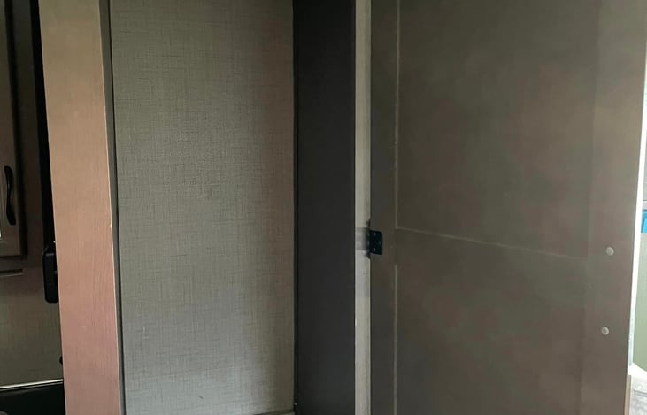 The wardrobe next to the bathroom has ample space for clothes and also contains a coffee maker that can brew a pot or k cups for your convenience.