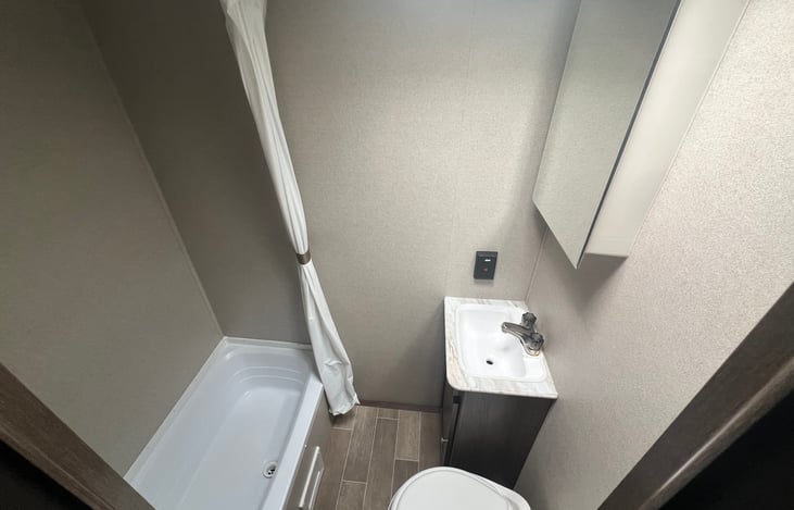 Clean bathroom with shower, vanity and toilette.