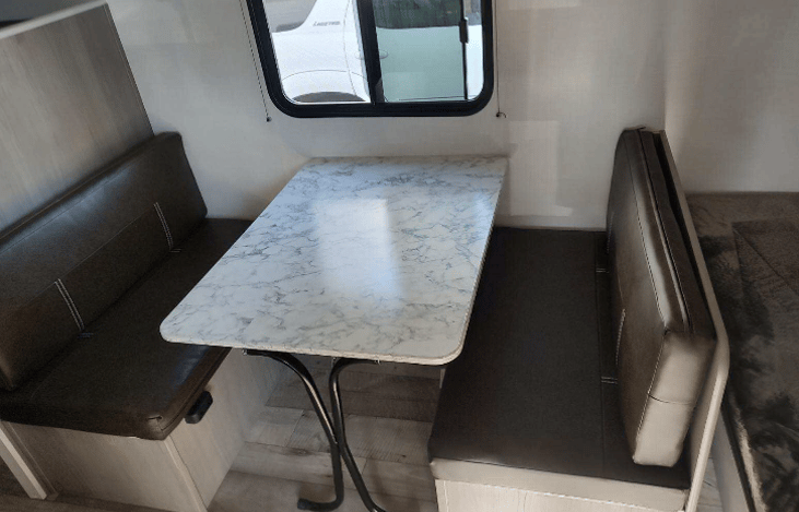 Table becomes another bed. Linens etc. are stored under the benches.