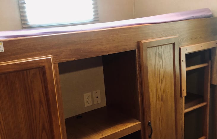 twin bunk up top, storage below with closets and pull out drawers, you can bring your own TV and hook up to campsite wi-fi