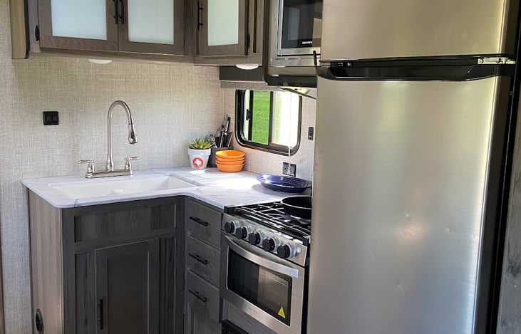 Refrigerator, freezer, double sink, oven, stove top and a microwave. What else do you need in a kitchen?