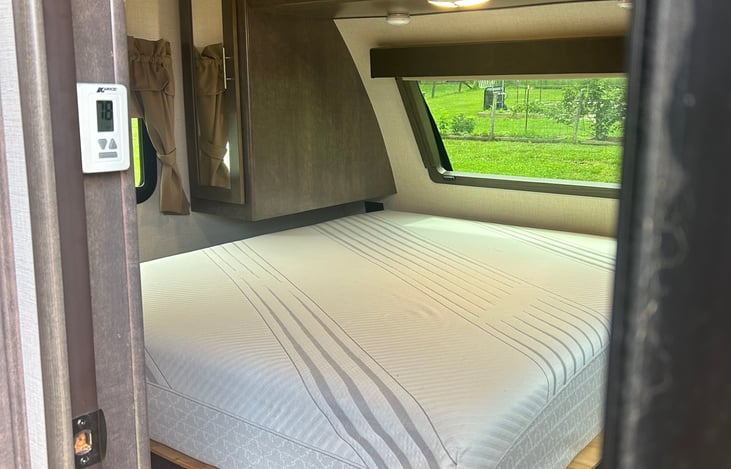 Large window over primary bed allows for natural sunlight. Blind closes for sleeping in!