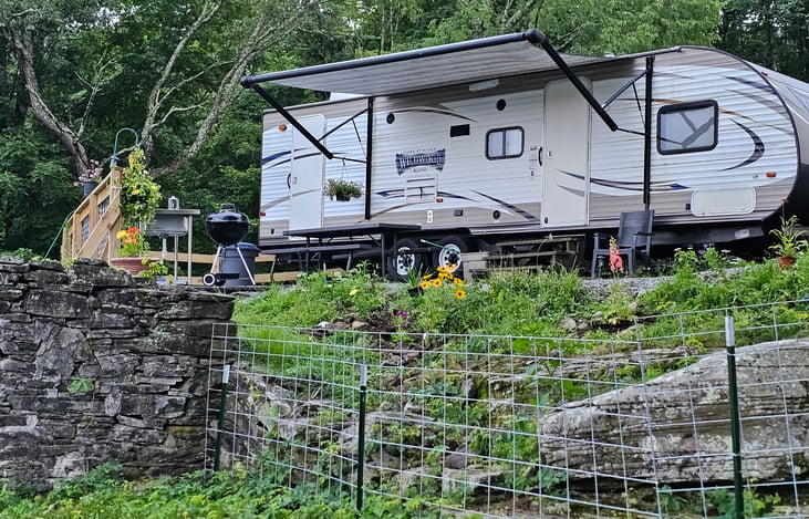 Camper is enclosed in a protected area so you can enjoy the sheep and they will not come in and eat the beautiful flower area
