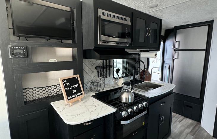 Entertainment center provides AM/FM radio equip with bluetooth options for indoor and outdoor speakers. TV  swivels out and is a smart TV that has streaming options if wifi is availible