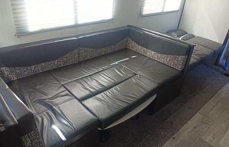 View of both dining table and sofa converted to beds