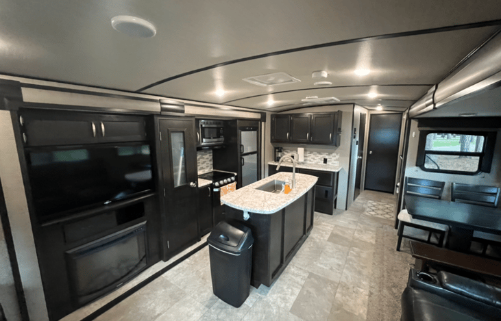 Main: TV, theatre seating, kitchen, and dining