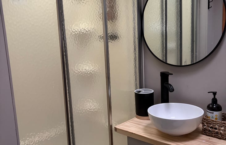 Custom bathroom sink with glass door shower