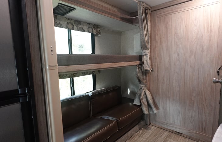 Flip down bunk and sleeper sofa.