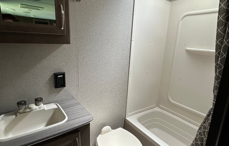 The shower is large enough for an adult and the tub will allow you to give the little ones a bath.