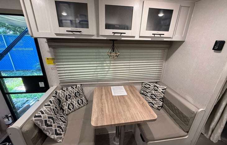 Dinette with overhead and underseat storage.