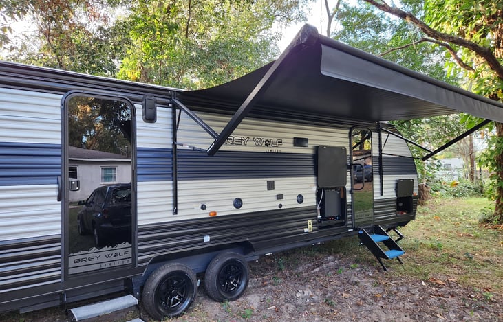 Exterior of the RV!  The awning is 3/4 of the way out!!
You can see the outdoor "kitchen" which has a mini fridge, ice maker, outdoor shower and cook top- great for tailgating or family BBQs