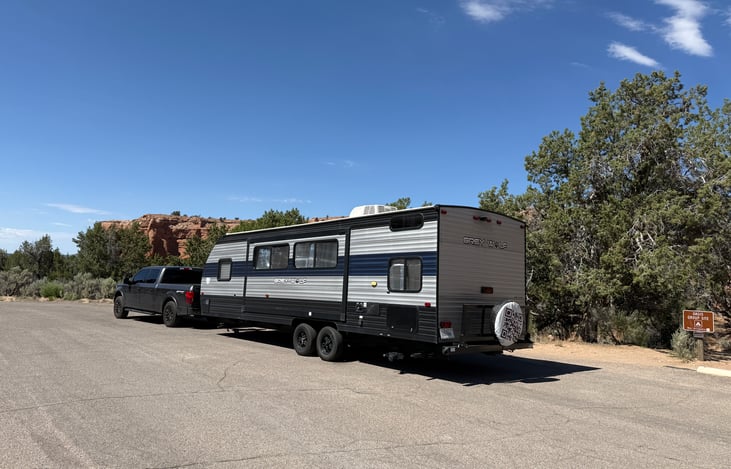10. Exterior Side View
Modern Grey Wolf travel trailer featuring a power awning, outdoor entertainment space, and sleek exterior design.