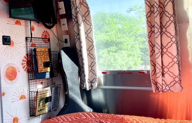 This glamping Airstream rental has high vibrational decor along with soft fabrics and fluffy pillows to add comfort. Linens included are fresh sheets and pillowcases with master bedding and twin bed.