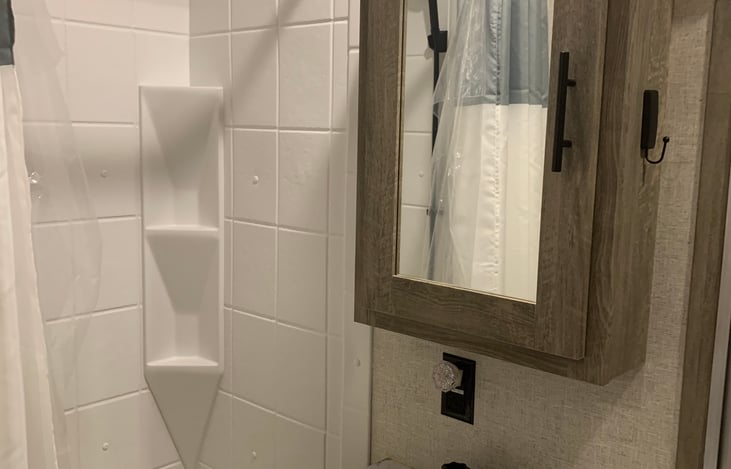 Back bathroom for bunk area with toilet and tub/shower.