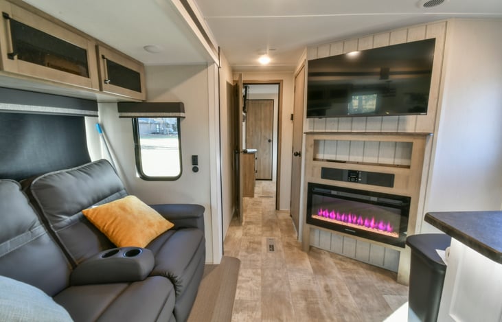 Living area with fireplace, TV, and theatre seating