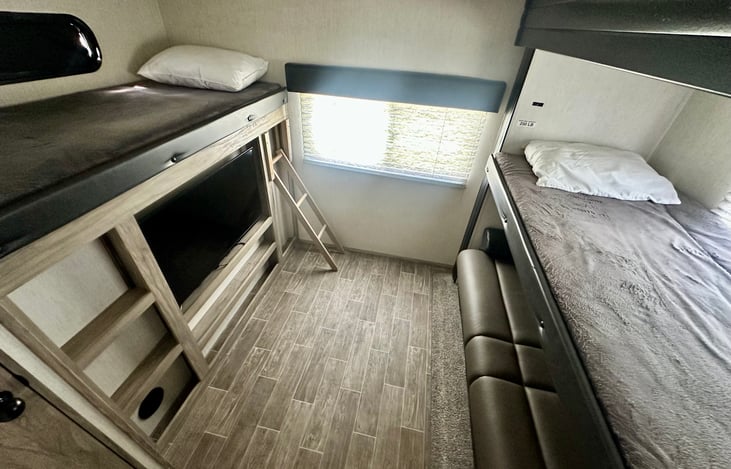 Bunkroom with two twin bunks, jackknife sofa (full size) and separate 1/2 bath