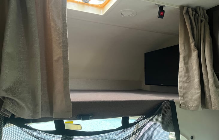 Above cab loft bed (king size) - the tv can extend out on an arm so you can use it for the living room also
Pro tip: our teenager claims this as her bed because the curtains close & she has privacy.