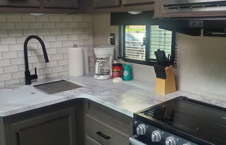 Kitchen contains all utensils, 1 big & small pot, 1 frying pan, coffee pot, toaster, pitcher, knives, cups, & plates. There are some spices in pantry cabinets along with cleaning supplies under sink.