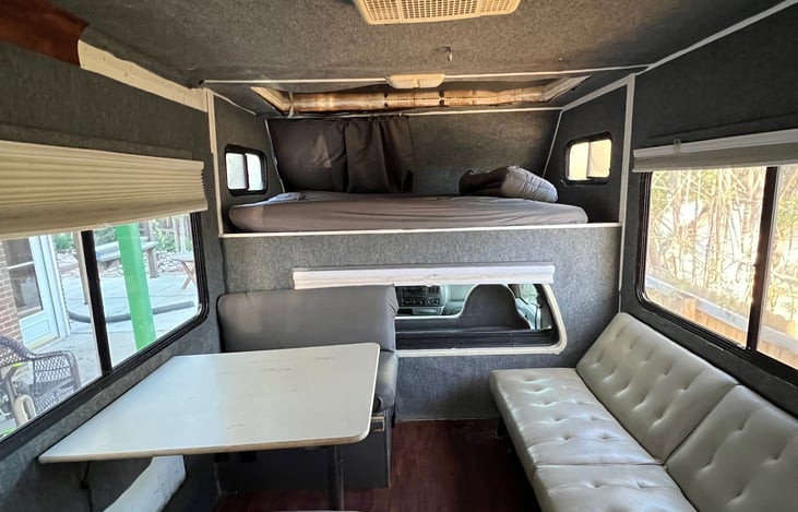 A roof repair has been done by a professional RV mechanic to replace a section over the bed with aluminum sheeting.