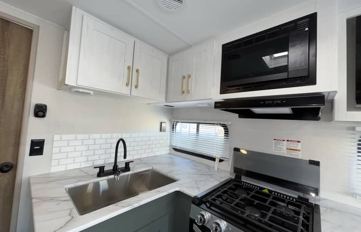 Kitchen area, Microwave, stove, sink and oven. Plenty of counter space