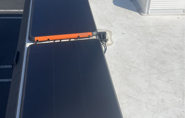 Four 100 W solar panels mounted on roof