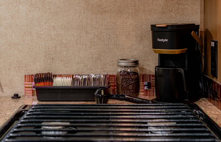 Compact single serve coffee maker and reusable filter, plus coffee and tea essentials to get you started.
