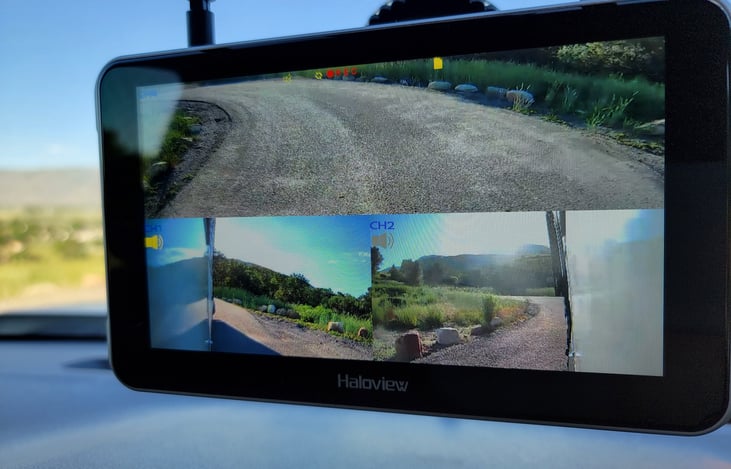 This trailer has side view and rear view cameras to show an all around snapshot of the trailer. Really useful for lane changes or backing up!