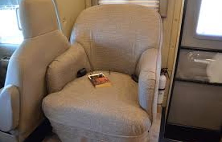 Chair behind front seats passenger side.