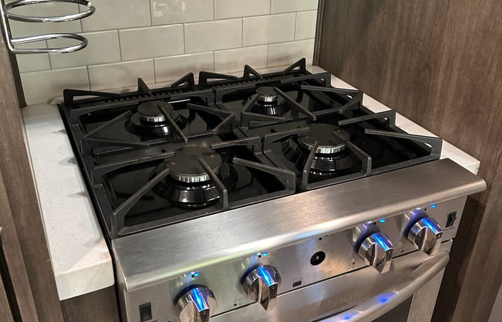 Four burner propane stove with lighting. 
(Oven does not work but there is a great convection oven in the microwave above it*)