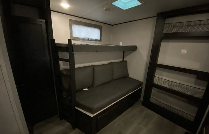 Spare bedroom couch and top bunk