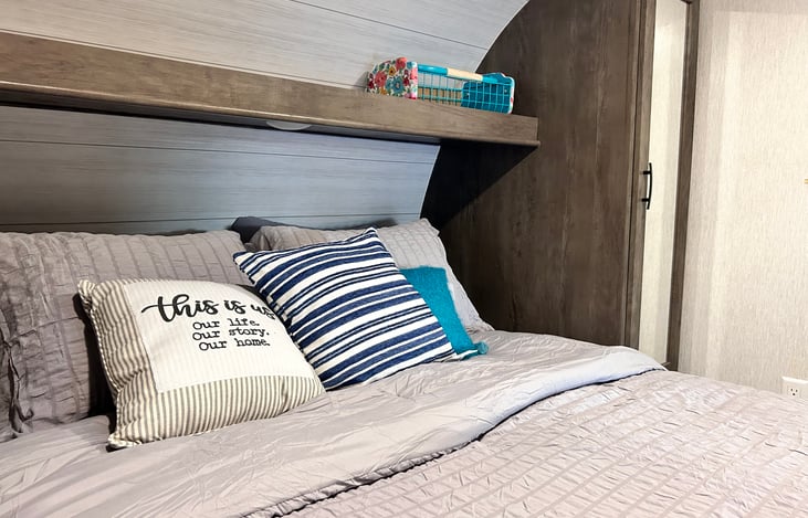 Private bedroom sliding door with snap lock. Queen size bed with foam topper, bedding, & pillows provided.