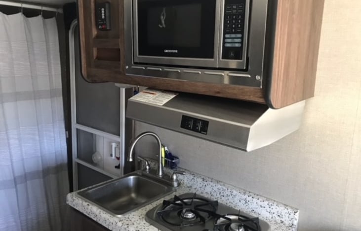 sink and 2 gas burners with MW above