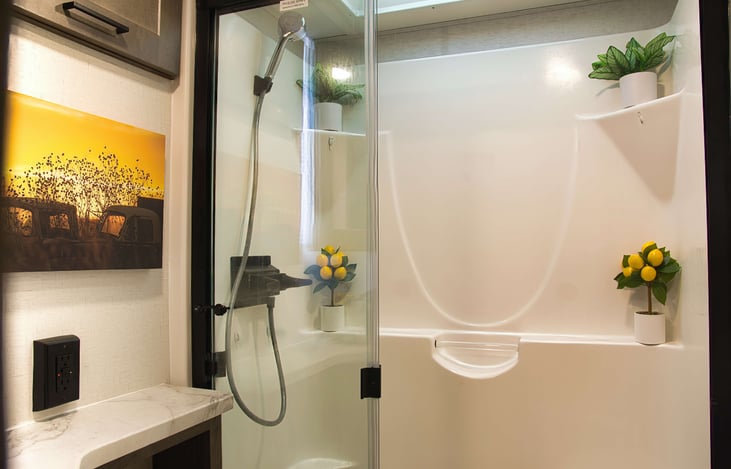 An especially roomy shower with adjustable shower head.