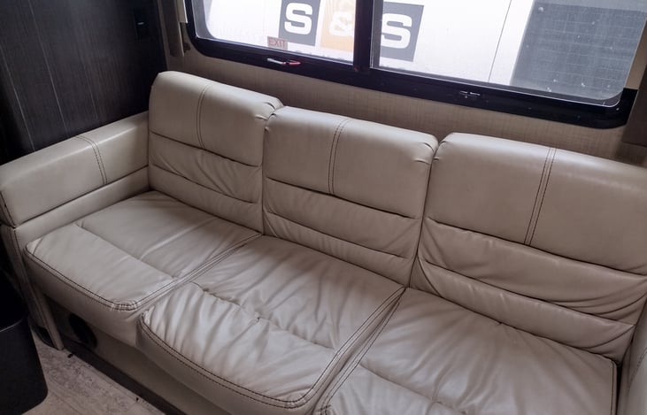 Very comfortable 3 adult seat couch equipped with seatbelts for kids' carseats.