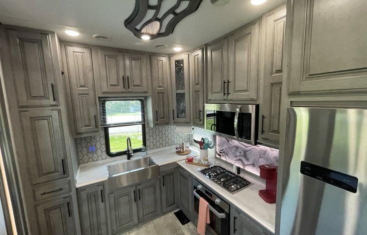 Gourmet Kitchen & Coffee Bar: Fully equipped modern kitchen with all utensils included, plus a dedicated Keurig coffee station to kickstart your mornings.