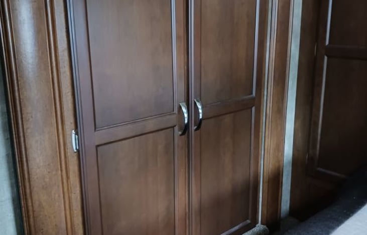 Bedroom slide closet. TV in the corner.