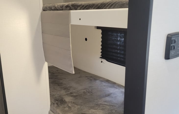 Extra long twin bunks with convenient storage for books, phones, etc.