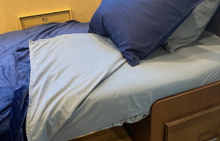 Table bed, sleeps one. Bedding is included.