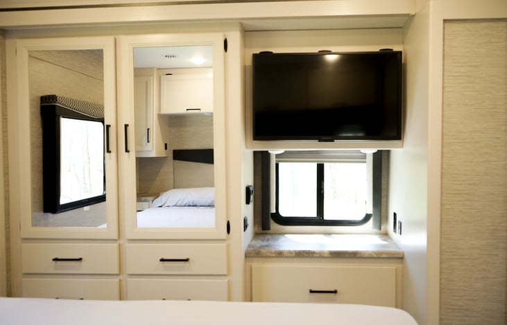 master bedroom features its own tv and spacious closet