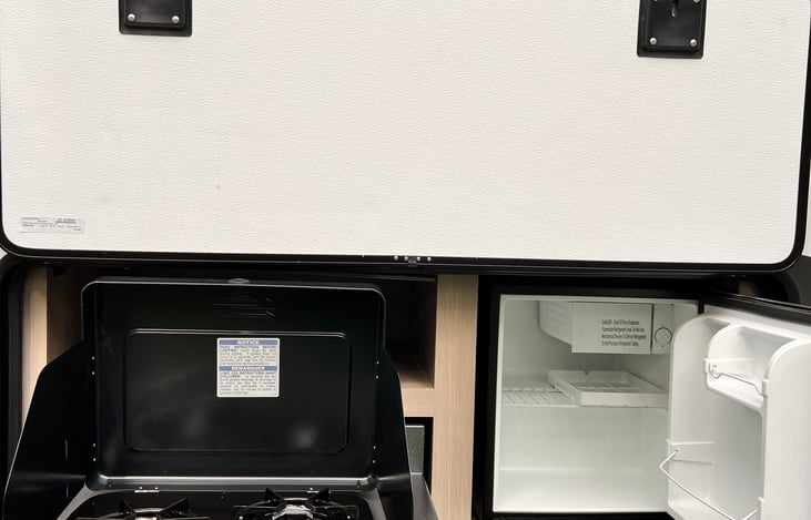 Outdoor kitchen with 2 propane burners and mini fridge. BBQ utensils included!