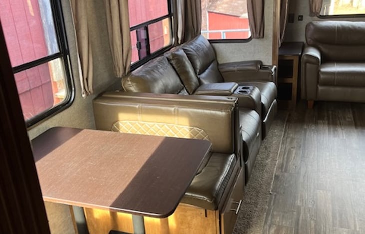 Fourth slide in the living area houses the dinette and reclining heated massaging chairs!