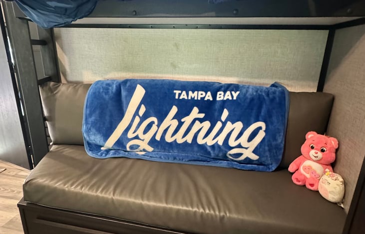 Couch in bunk house. Top bunk above the couch.