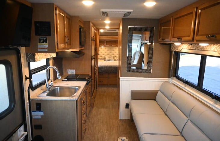 Custom upholstered couch folds down into bed.  Includes a removable table for dining (not shown).