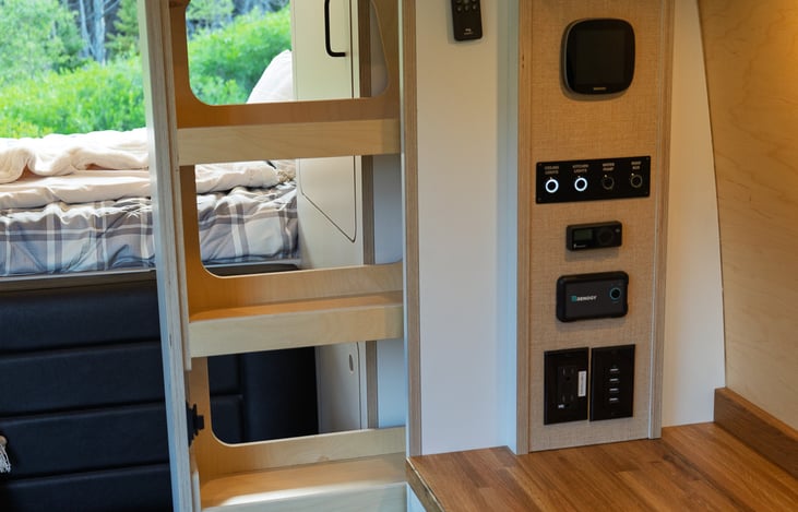 Floor to ceiling pantry to store all the snacks for your epic trip. This is also command central for lights, water pump, heater, solar/battery info, etc.