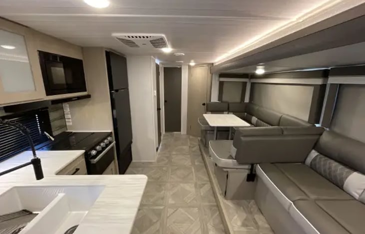 Living Room  and Full Indoor Kitchen/Dining Area. 

Kitchen Table converts to make more sleeping arrangements and Couch folds to create a bed as well.