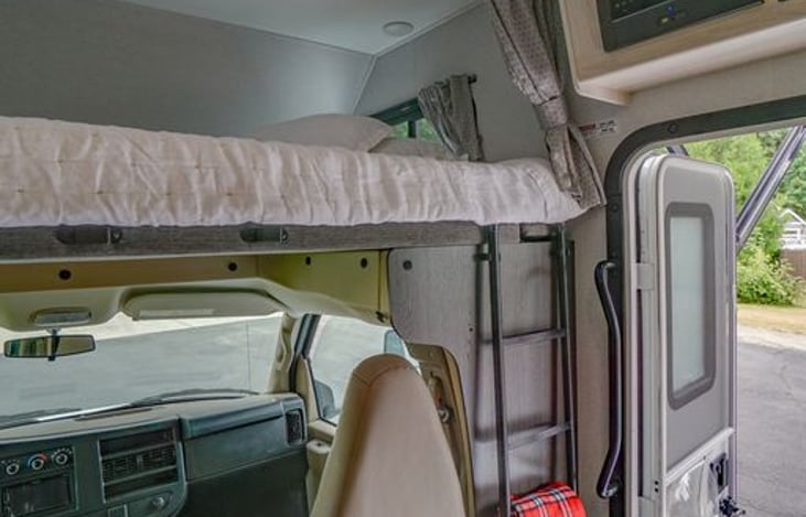 Bunk room with added gel queen mattress. Linen quilt and pillow shams!
We will add down comforter for the cold season! Privacy curtains! Ladder moves to the middle when bunk is in use.